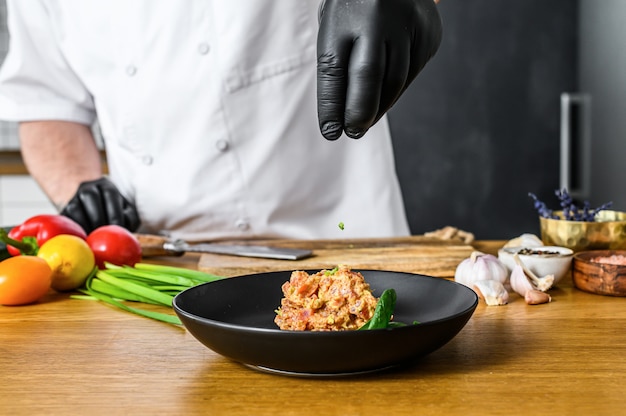 chef hands preparing dish